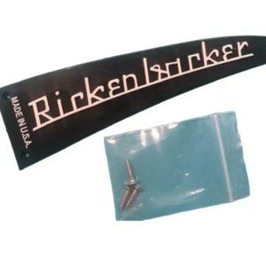 BLACK RICKENBACKER TRUSS ROD COVER WITH RAISED WHITE LETTERS
